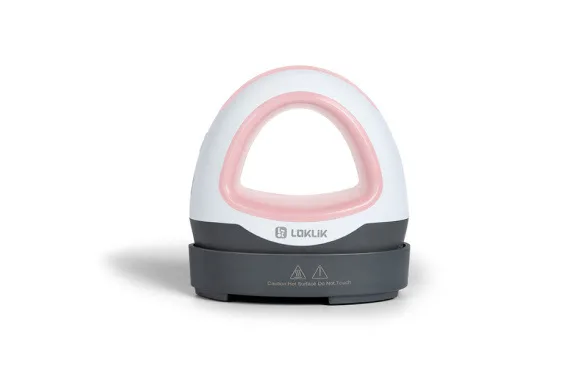Side view of a LOKLik Mini Heat Press in romance pink on its safety base.