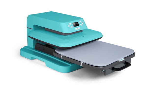 Auto Heat Press in LOKLiK blue at an angle with the large ironing board pulled out showing the heat press mat.