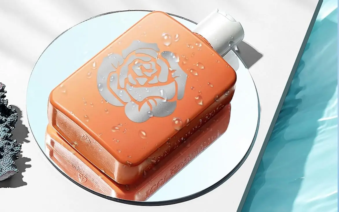 Orange plastic soap bottle lying on top of a mirror. It has a decal of a rose in mirror metallic permanent adhesive vinyl.